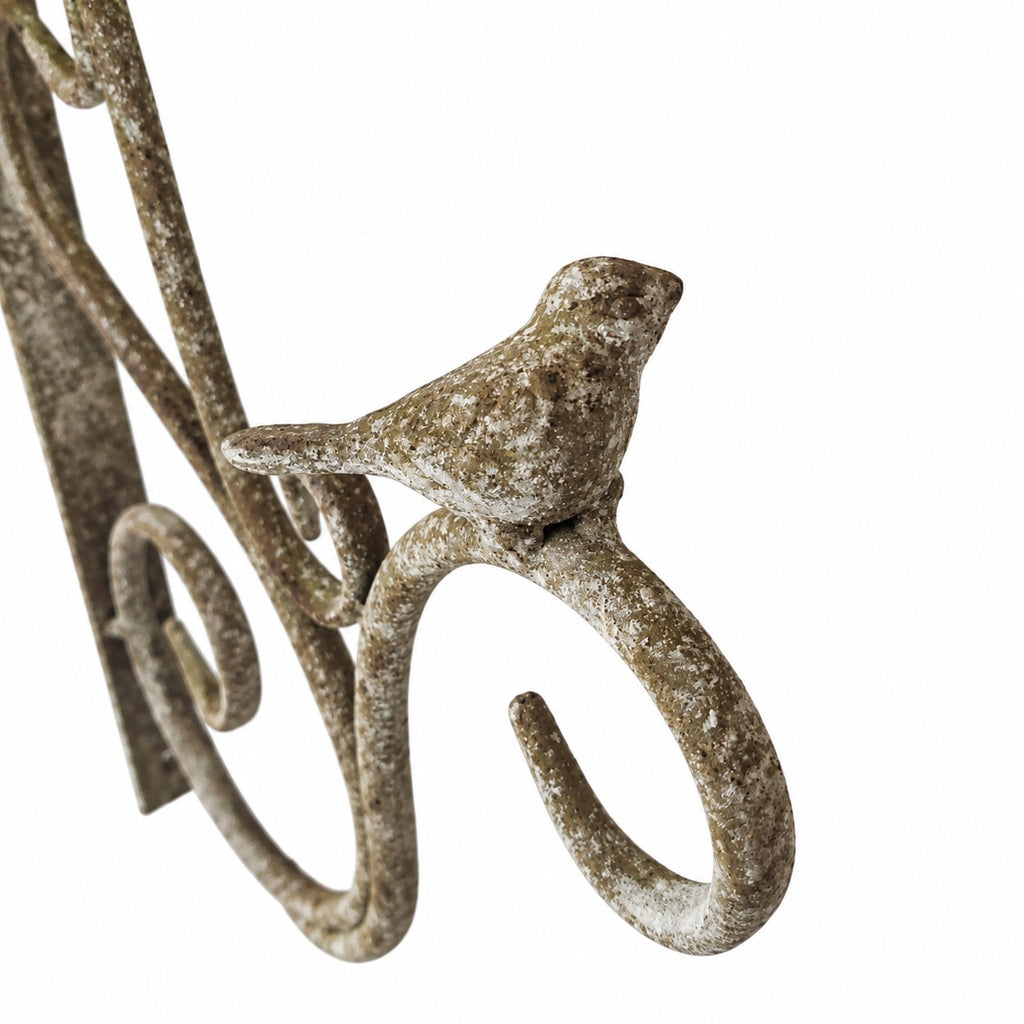 Decorative aged metal wall bracket with bird