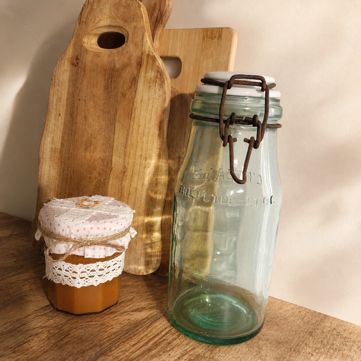 Ancien bocal de conservation L'Idéale en verre avec couvercle en céramique, parfait pour une décoration de cuisine campagne chic ou brocante.