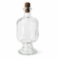 Bouteille ancienne en verre transparent sur pied, objet de brocante au charme authentique pour une décoration campagne chic.