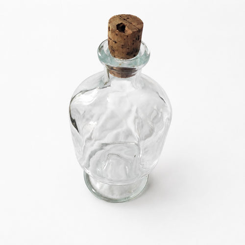 Antique glass bottle with a footed base